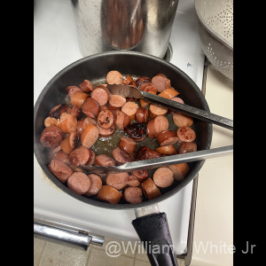 Searing smoked country and Andouille sausage